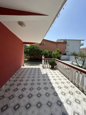 a balcony of a house with a tile floor at Apartments TODOR in Bar