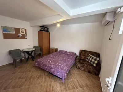 a bedroom with a purple bed and a table and chairs at Apartments TODOR in Bar