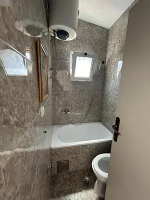 a bathroom with a bath tub and a toilet at Apartments TODOR in Bar