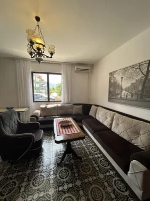 a living room with a couch and a table at Apartments TODOR in Bar