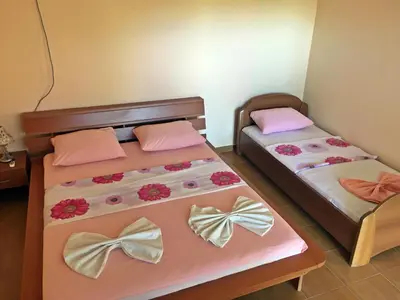 two beds in a room with bows on them at Apartments Pelinkovic in Ulcinj