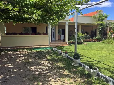 a house with a lawn in front of it at Apartments Pelinkovic in Ulcinj