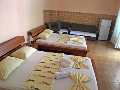 a living room with two beds and a couch at Apartments Pelinkovic in Ulcinj