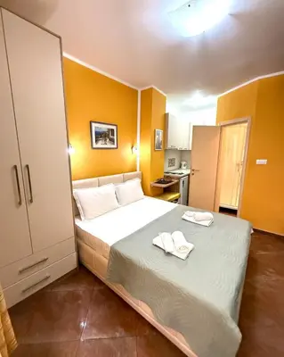 a bedroom with a bed with two towels on it at Apartments Casa del Sol Jovana in Kotor