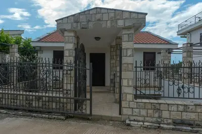 a house with a gate in front of it at Villa Julia in Petrovac na Moru