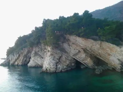 an island in the water with trees on it at Villa Julia in Petrovac na Moru