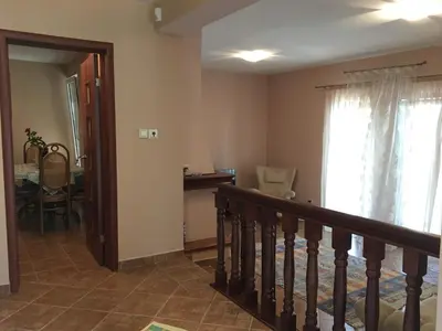 a living room with a staircase and a window at Villa Julia in Petrovac na Moru