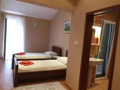 a small bedroom with two beds and a sink at Villa Julia in Petrovac na Moru