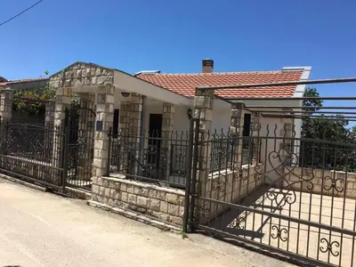 a fence in front of a house at Villa Julia in Petrovac na Moru