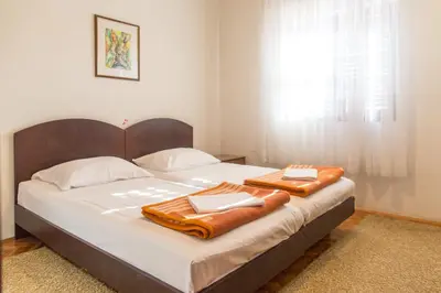 a bedroom with a bed with two towels on it at Guesthouse Blue Coast in Budva
