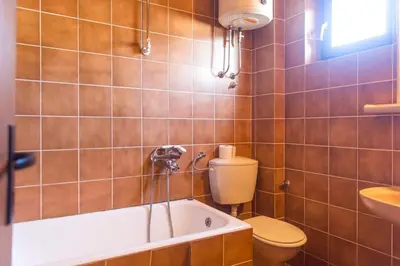 a bathroom with a tub and a toilet and a sink at Guesthouse Blue Coast in Budva