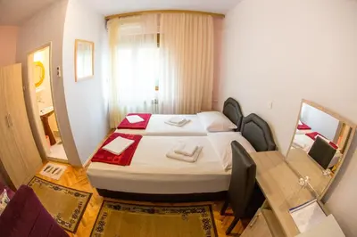 a small room with a bed and a window at Guesthouse Blue Coast in Budva