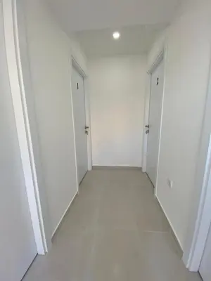 an empty hallway with white walls and white doors at Ceka Apartments in Ulcinj