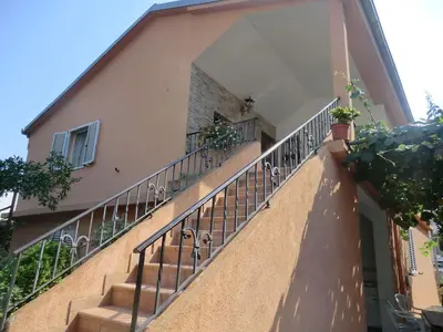 a balcony of a building with stairs and plants at Holiday Home Hermes in Budva