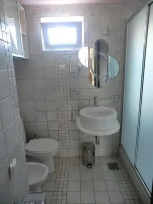 a bathroom with a sink and a toilet at Holiday Home Hermes in Budva
