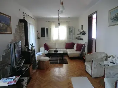 a living room with a couch and a tv at Holiday Home Hermes in Budva