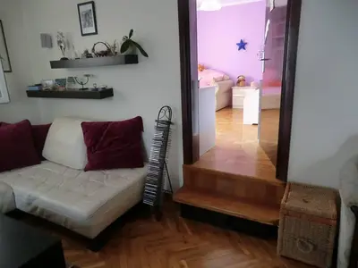 a living room with a couch and a bedroom at Holiday Home Hermes in Budva