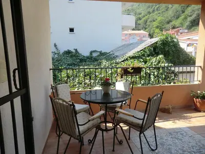 a table and chairs on a balcony with a view at Holiday Home Hermes in Budva