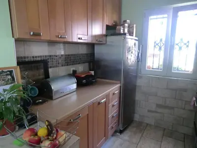 a kitchen with a refrigerator and a bowl of fruit at Holiday Home Hermes in Budva