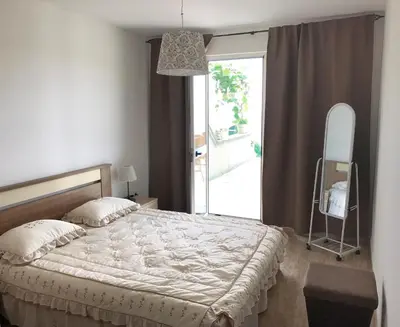 a bedroom with a bed and a large window at Apartment Jana in Ulcinj