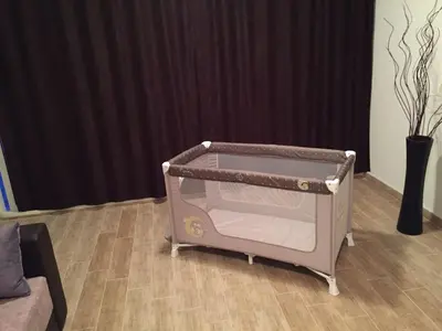 a baby crib in a room with a curtain at Apartment Jana in Ulcinj