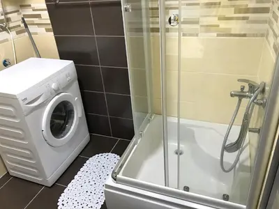 a bathroom with a washing machine and a shower at Apartment Jana in Ulcinj