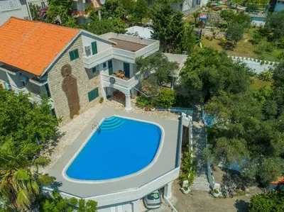 an overhead view of a swimming pool in front of a house at The Turtles Garden in Becici