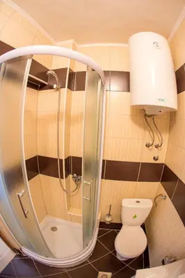 a bathroom with a toilet and a glass shower at The Turtles Garden in Becici