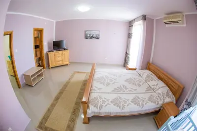 a bedroom with a bed and a television in it at The Turtles Garden in Becici