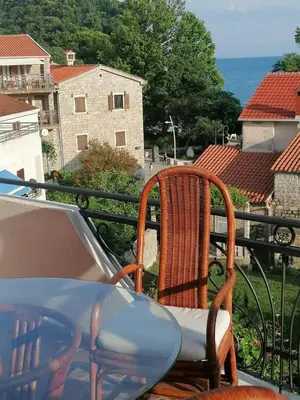 a table and chairs sitting on a balcony at Apartment Dmitr Petrovac in Petrovac na Moru