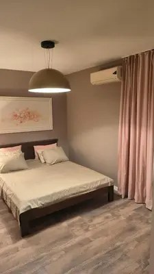 a bedroom with a bed and a pink curtain at Apartment Dmitr Petrovac in Petrovac na Moru