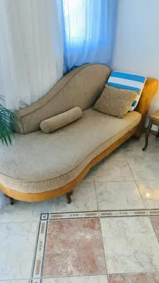 a couch with two pillows on it in a room at Apartment Dmitr Petrovac in Petrovac na Moru