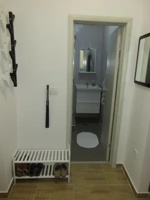a bathroom with a toilet and a sink with a mirror at Summer apartment in Bar