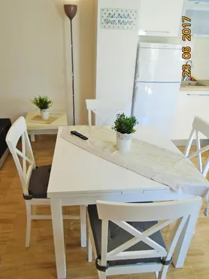 a white table and chairs with a plant on it at Summer apartment in Bar