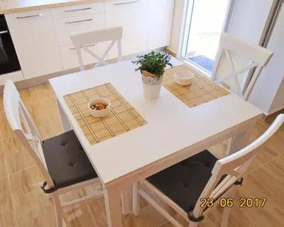 a white table and chairs in a kitchen at Summer apartment in Bar