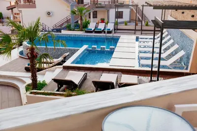 an overhead view of a swimming pool with chairs and a building at Hotel Princess & Spa in Ulcinj