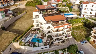 an aerial view of a building with a swimming pool at Hotel Princess & Spa in Ulcinj