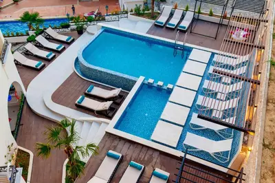 an overhead view of a swimming pool with lounge chairs at Hotel Princess & Spa in Ulcinj