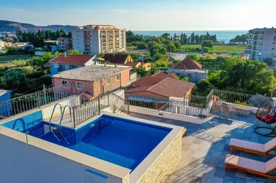 a swimming pool on the roof of a house at De Lux Apartments Luka in Bar