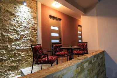 a group of chairs and a table in a room at De Lux Apartments Luka in Bar