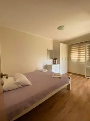 a bedroom with a large bed in a room at Apartments Luna in Bar