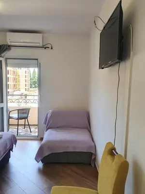 a room with a bed and a flat screen tv at Apartments Luna in Bar