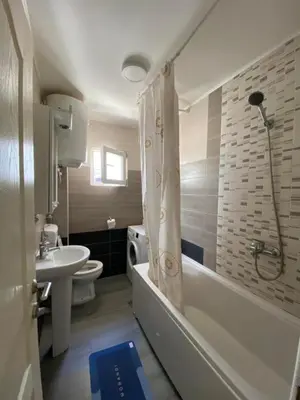 a bathroom with a sink and a tub and a toilet at Apartments Luna in Bar