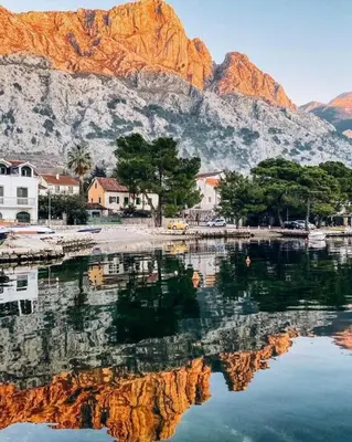 a body of water with mountains in the background at Garden apartmant near sea in Kotor