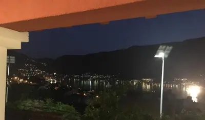 a view of a city at night with a street light at Apartment Apollo in Kotor