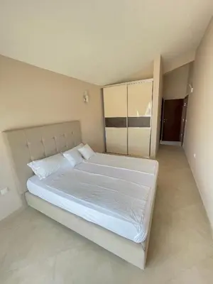 a bedroom with a large white bed in a room at Apartments Harris in Ulcinj
