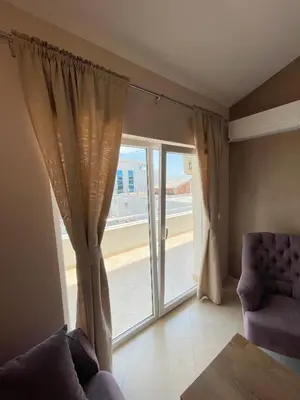 a living room with a large window and a couch at Apartments Harris in Ulcinj