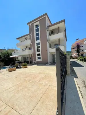 a large apartment building with a large courtyard at Apartments Harris in Ulcinj