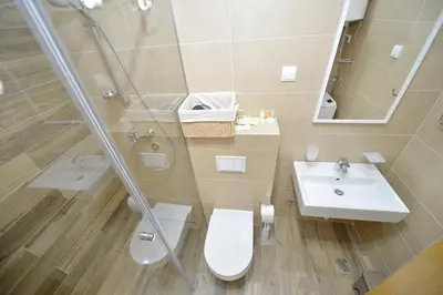 a bathroom with a toilet and a sink and a shower at Apartments Posto Capitano 0202 in Kotor
