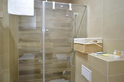 a shower with a glass door in a bathroom at Apartments Posto Capitano 0202 in Kotor